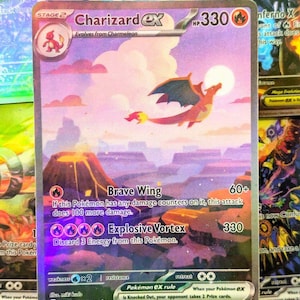 May include: A Charizard EX Pokémon card featuring a flying orange dragon against a purple and pink landscape with a volcano. The card has the text "Charizard EX" and "Brave Wing" and "Explosive Vortex" printed on it.