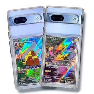May include: Two clear phone cases with a light blue frame, each holding a Pok&eacute;mon trading card. One card features a Diglett family, and the other showcases Pikachu with other characters. Both cards have Japanese text and holographic effects.