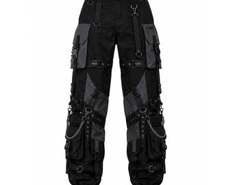 May include: Black and dark gray cargo pants featuring multiple utility pockets, adjustable straps with buckles, metal D-rings, and silver-toned chains. The pants include a waist belt with a plastic buckle and drawstring closures at the leg hems.