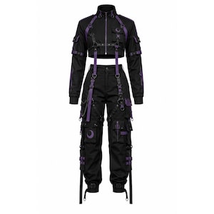 May include: A black cropped jacket and matching cargo pants set featuring purple accents. The jacket has a high collar, long sleeves, and chest pockets. The pants include multiple utility pockets, straps, buckles, a silver chain, and crescent moon symbols.