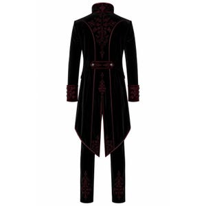 May include: Black velvet tailcoat and matching pants with burgundy embroidery. The long-sleeved coat features a high collar, decorative buttons, and ornate patterns. The pants have matching embroidery.