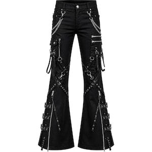 May include: Black flared pants with multiple silver zippers, chains, and straps. The pants have cargo pockets and decorative metal rings. The design features a low waist and a wide, bell-bottom style.