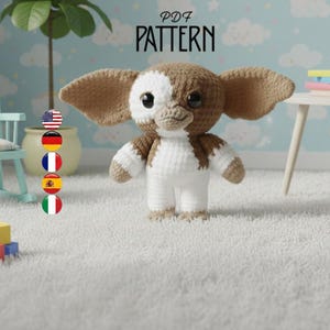 May include: A crocheted Gremlin doll with large ears, white and brown coloring, and large eyes. The doll is standing on a white rug in a nursery setting. The text "PDF PATTERN" is above the doll.