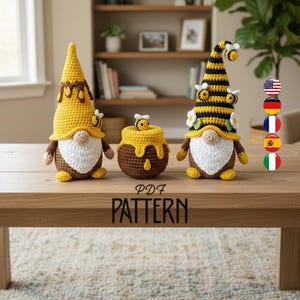 May include: Three crochet gnome figures with bee-themed hats and a honey pot. The gnomes have white beards, brown bodies, and yellow hats with brown accents. The honey pot is brown with yellow honey dripping down. The text "PDF PATTERN" is on the table.