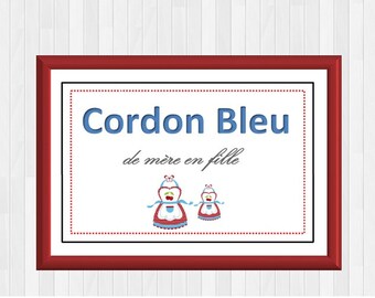 May include: A framed print with a red frame and a white background. The text "Cordon Bleu de mère en fille" is printed in black and blue. Two cartoon images of women wearing red and white aprons with blue accents are below the text.