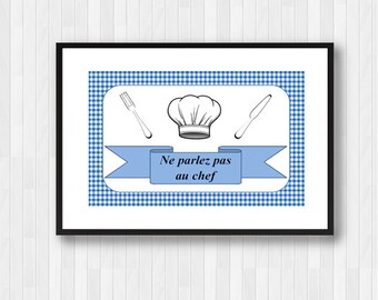May include: Framed print with a blue and white gingham background. It features a chef's hat, fork, and knife illustrations. A blue banner displays the French text "Ne parlez pas au chef".