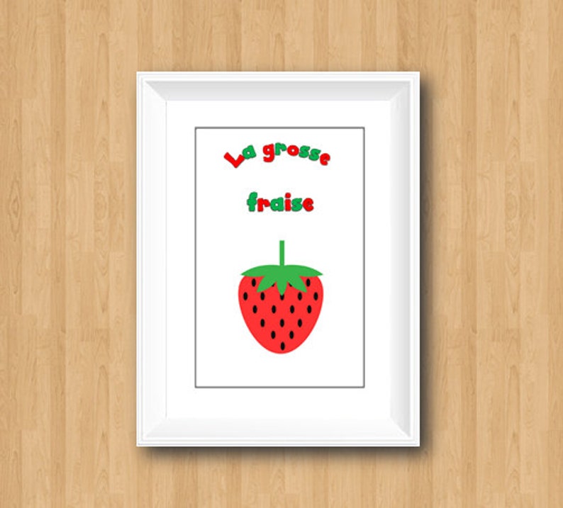 May include: A white framed print with the text "La grosse fraise" in red and green letters. A red and green cartoon strawberry is below the text.