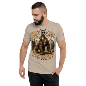 Who's The Ass Now? Funny Bigfoot Shirt | Donkey Riding Sasquatch T-Shirt | Camping Humor Tee | Funny Outdoor Shirt | Cryptid Gift For Men