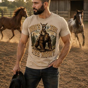Who's The Ass Now? Funny Bigfoot Shirt, Donkey Riding Sasquatch Tee, Camping Humor Shirt, Cryptid Gift for Men image 1