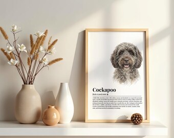May include: A framed vertical wall art print featuring a realistic illustration of a brown Cockapoo dog with the text Cockapoo and a dictionary-style definition below the image, displayed alongside two ceramic vases and a small pinecone.