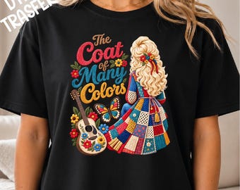 May include: A black t-shirt featuring a graphic of a person with long blonde hair seen from behind, wearing a patchwork coat. The design includes a guitar, a butterfly, flowers, and the text The Coat of Many Colors in red, blue, and yellow.