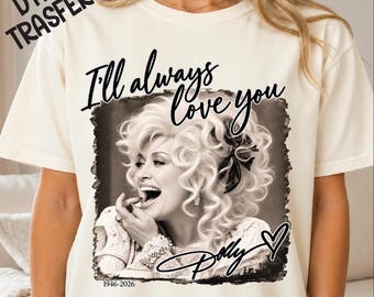 May include: A cream-colored t-shirt featuring a black and white photographic print of Dolly Parton. The text "I'll always love you" is printed above the image, with "Dolly" and a heart symbol below, and the years "1946-2026" at the bottom.