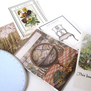 May include: A collection of vintage-style bookplates and labels. Designs include floral illustrations, a globe, a chair, and a scene with a rabbit. The text "EX-LIBRIS" and "This book belongs" are visible.