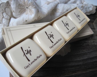 May include: Four white rectangular soap boxes with the text "Fiji Guy Laroche Paris" printed on each box. The boxes are arranged in a row, with the top box slightly offset from the others.