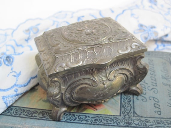 Vintage Footed Trinket Box Jewelry Holder Made in Japan Ornate Metal Silver Plated Hinged Casket Red Lining Embossed Floral Relief Design