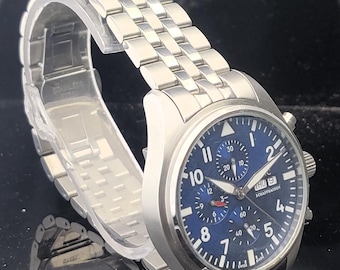 Reloj cronógrafo IWC vintage, analógico automático, de acero inoxidable, esfera azul.