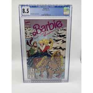 May include: A graded comic book featuring "Barbie #2" from Marvel Comics. The cover art depicts Barbie and another person in a horse-drawn sleigh in a snowy scene. The comic is encased in a protective holder with a CGC Universal Grade of 8.5.