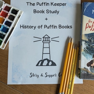 May include: A still-life image featuring a book study guide titled "The Puffin Keeper Book Study + History of Puffin Books" with a lighthouse illustration.  Also includes a watercolor paint set, pencils, and a vintage book titled "The Puffin".