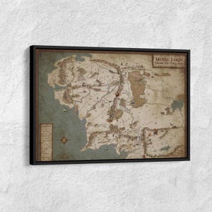 May include: A framed map of Middle Earth from the Third Age, with a vintage style. The map shows detailed illustrations of mountains, rivers, and settlements, with text labels and a compass rose. The frame is black.
