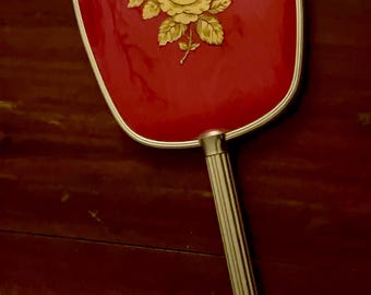 Espejo de tocador vintage rojo y dorado con estampado floral.