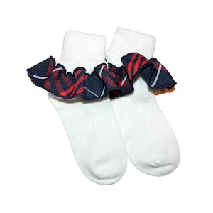 May include: White ankle socks with a red, blue, and white plaid ruffle trim.