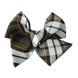 May include: A brown, white, and gold plaid bow. The bow is tied in a knot and has a pointed shape.