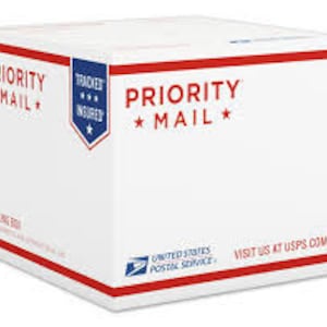 May include: A white Priority Mail box with the text "PRIORITY MAIL" printed in blue on the front. The box is labeled "TRACKED & INSURED" and has the United States Postal Service logo.