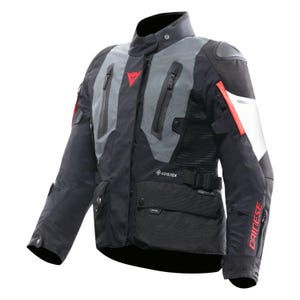 May include: Black and grey motorcycle jacket with red detailing. It features multiple zipped pockets, a high collar, and the red "DAINESE" logo on the sleeve. The jacket has a "GORE-TEX" label.