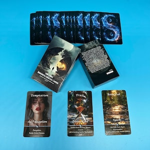 May include: A Yin Yang Insights Oracle Cards set on a blue surface. The image shows three boxes and several individual cards. The cards display images and text, including "Temptation," "Trust," and "Renewal."