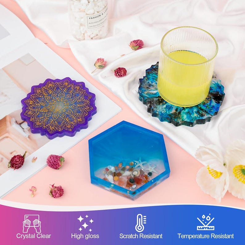 May include: A collection of handmade resin coasters in various shapes and designs. One coaster is a deep purple with a gold mandala pattern. Another is a hexagon shape with blue resin and small decorative elements. A third coaster is blue and green with a glass of yellow liquid on top.