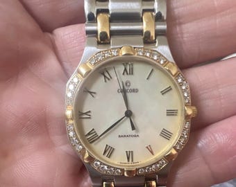 Concord Saratoga tweekleurig quartz horloge met diamanten ring, Romeinse cijfers