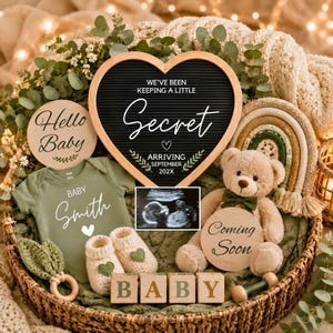 May include: A wicker basket containing a heart-shaped letter board with the text WE'VE BEEN KEEPING A LITTLE Secret ARRIVING SEPTEMBER 202X, a green baby bodysuit with BABY Smith, a sonogram, a teddy bear, baby booties, and wooden blocks spelling BABY.