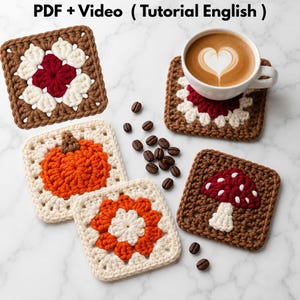 May include: Four square crochet coasters featuring floral, pumpkin, and mushroom motifs in brown, cream, orange, and red yarn. A white ceramic mug with heart-patterned latte art sits on one coaster. Text reads: PDF + Video ( Tutorial English ).