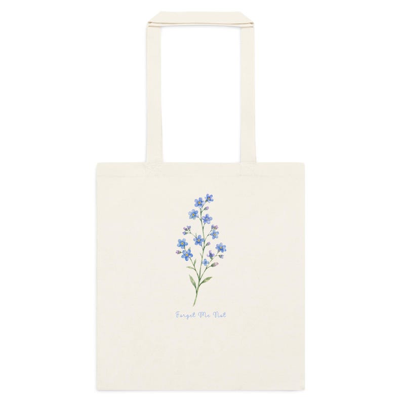 Cream cotton tote bag featuring delicate blue forget me not flowers and “Forget Me Not” text inspired by Outlander and Scottish wildflowers.