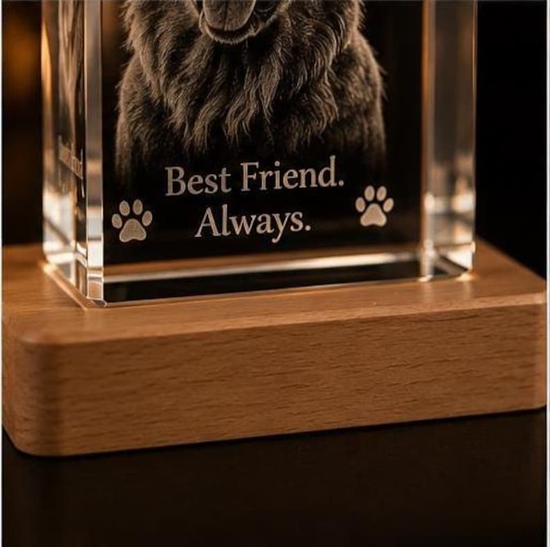 May include: A clear rectangular glass block featuring a laser-etched portrait of a dog. The glass is engraved with the text "Best Friend. Always." and two paw print icons. The glass block is mounted on a rectangular light-colored wooden base.