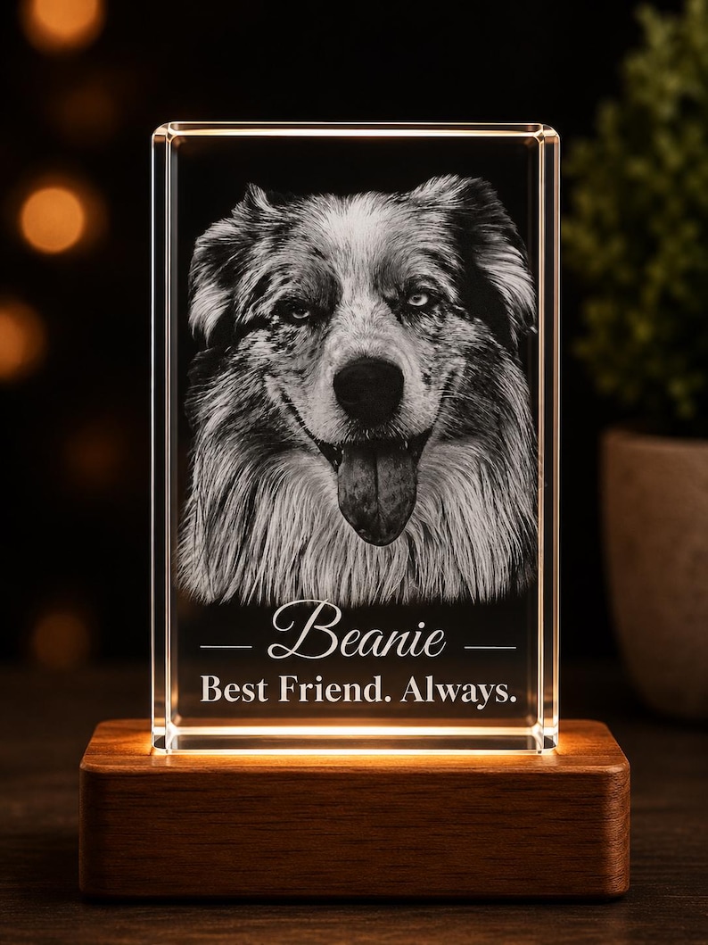 May include: A rectangular clear glass block featuring a laser-etched portrait of a dog with its tongue out. Below the dog, the text reads Beanie and Best Friend. Always. The glass block sits on a rectangular wooden base with internal lighting.