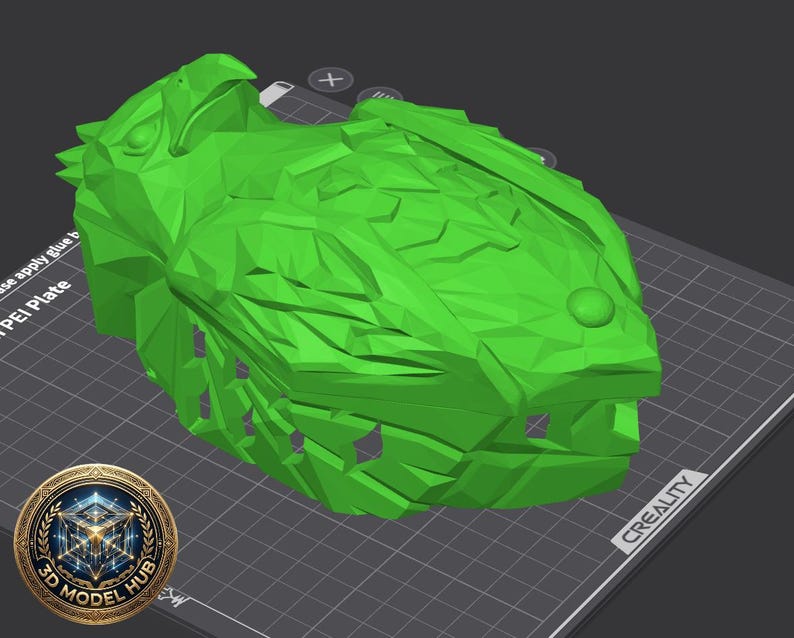 May include: A bright green, 3D-printed model of a fish head, resting on a gray surface with a grid pattern. The model has detailed scales and a prominent eye. A logo for "3D Model Hub" is in the lower left corner.