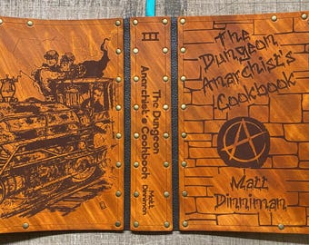 Leather covered copy of The Dungeon Anarchist's Cookbook by Matt Dinniman