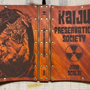 Kaiju Preservation Society by John Scalzi with leather cover