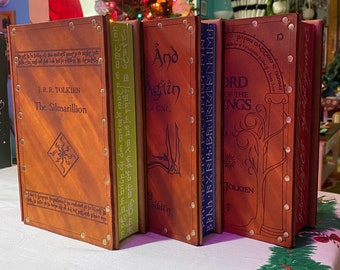 Set of three illustrated Tolkien novels with leather covers.