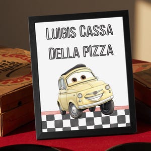 May include: A framed print featuring a cartoon illustration of a light yellow car with large brown eyes and a wide smile. The text "LUIGIS CASSA DELLA PIZZA" is printed in black above the car, which is positioned on a black and white checkered floor.