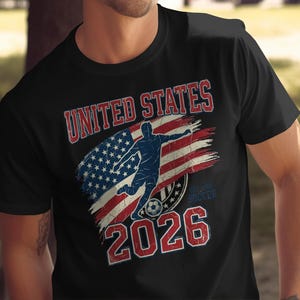 Black t-shirt with "UNITED STATES 2026 SOCCER" and US flag graphic.