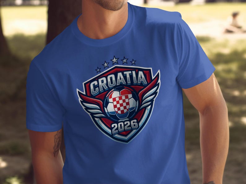 Blue t-shirt with Croatia 2026 soccer crest featuring wings and a checkered ball.