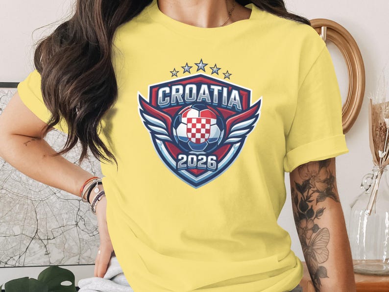 Croatia 2026 soccer crest with wings and stars on a yellow t-shirt.