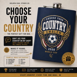 May include: A dark blue metal flask featuring a gold and white graphic of a soccer ball inside a shield emblem with wings, text reading CHOOSE YOUR COUNTRY EMBLEM 2026 WORLD CUP, and a small GG logo. The flask has a silver screw-top cap.