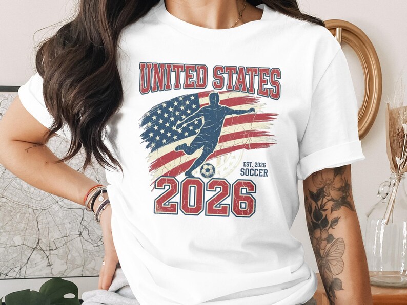 United States Soccer 2026 shirt with distressed American flag and player silhouette.