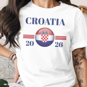 White t-shirt with "CROATIA 20 26" and a soccer ball with Croatian flag.