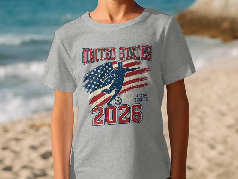 Gray t-shirt with "United States Soccer Est. 2026" and American flag graphic.