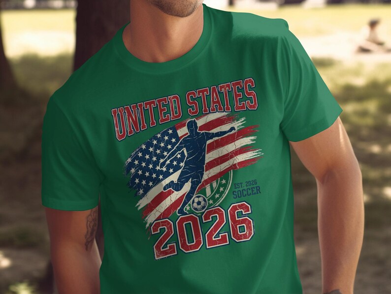Green t-shirt with distressed "UNITED STATES SOCCER EST. 2026" text and flag.
