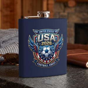Dark blue flask with "USA 2026 Football Crest" logo featuring wings and soccer ball.